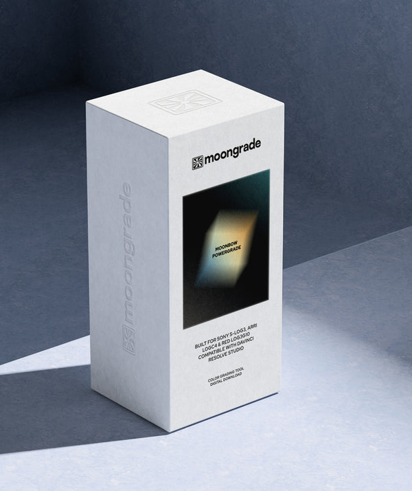 A white rectangular product box for moongrade, standing upright on a dark blue-gray surface against a matching dark background. The front of the box features a black square with a glowing yellow-green geometric shape and the text 'moonbow powergrade
